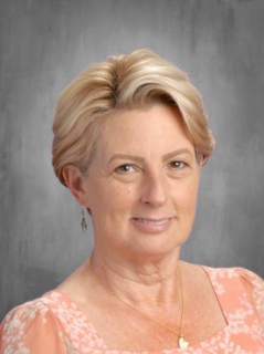 Tracey Hinkson is wearing a shirt with flowers.